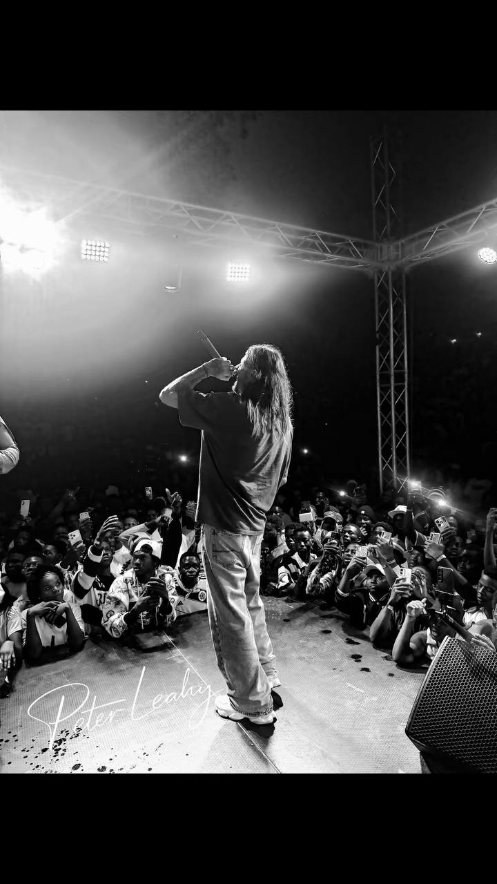Pete performing on stage to a packed crowd in Ghana